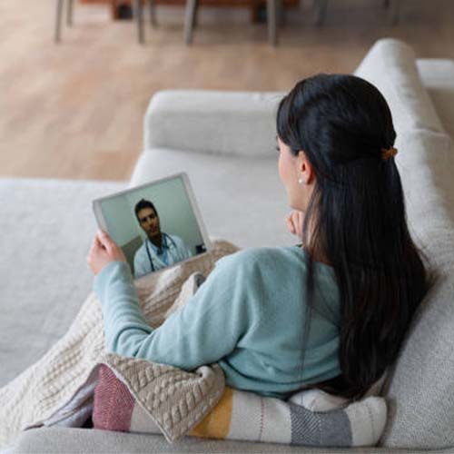 Woman receiving telehealth services at the comfort of home