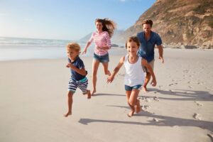 Children running on the beach, illustrating the Vitamin D and depression link through sunlight exposure.