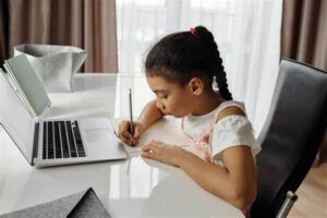 Child attending an online class, highlighting The Effects of Online Classes on Children's Mental Health.