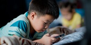 Child absorbed in cellphone - How the Internet Affects Children's Mental Health