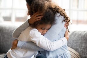 Mother hugging child - parenting a child with mental health issues