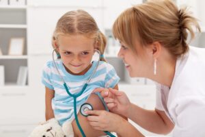 A doctor talking to a child during a mental health checkup, emphasizing the importance of a child's mental health.