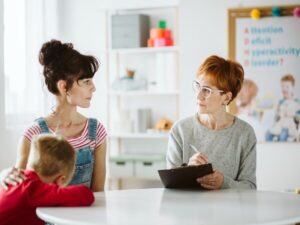 Parent, child, and therapist discussing key questions during a therapy session